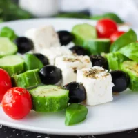 Fresh,Greek,Salad,Skewers,Served,On,White,Round,Plate